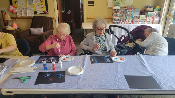 Residents engaged in a painting activity in a common area