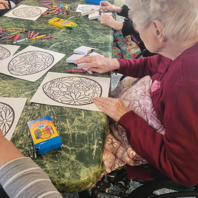 Residents coloring at a activity table