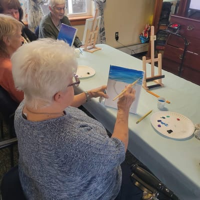 Residents participating in a painting activity
