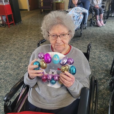 Resident creating an Easter craft with decorative eggs