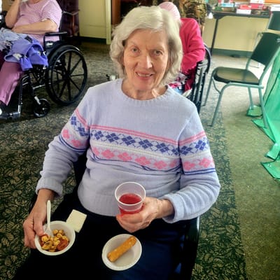 Resident enjoying snacks and a drink in a common area