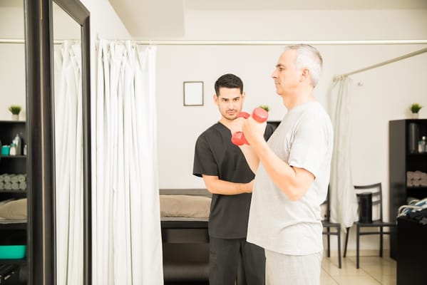 Physical therapy session with weights in a fitness area