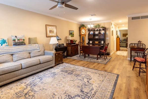Interior view of a cozy common area with seating and dining table
