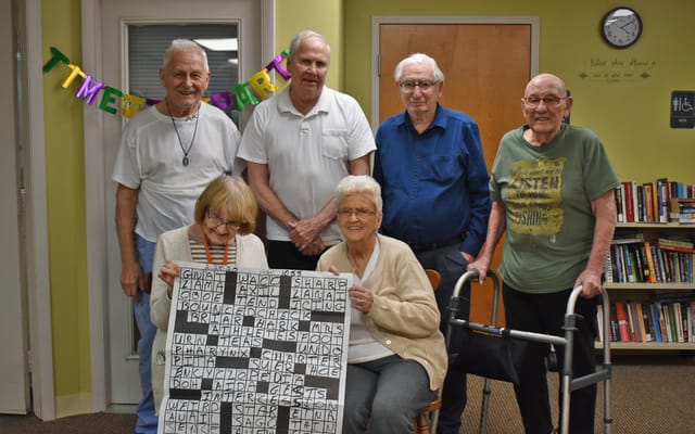 Residents enjoying a crossword puzzle activity together