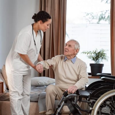 Staff assisting a resident in a cozy room