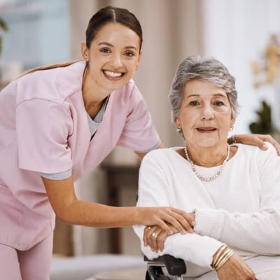 A caregiver assisting a senior resident in a bright interior space