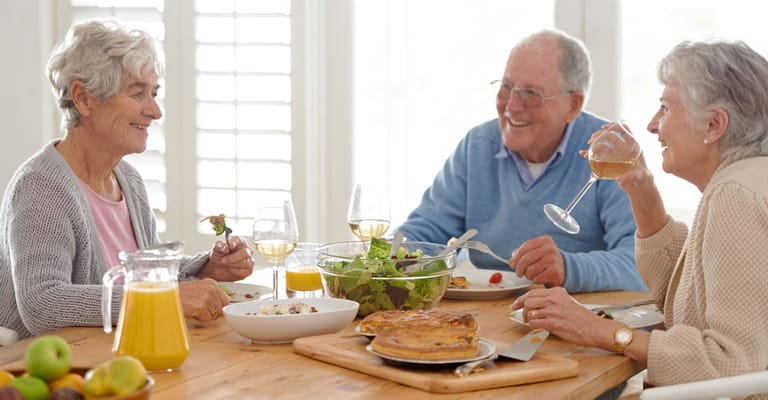 Three residents enjoying a meal together