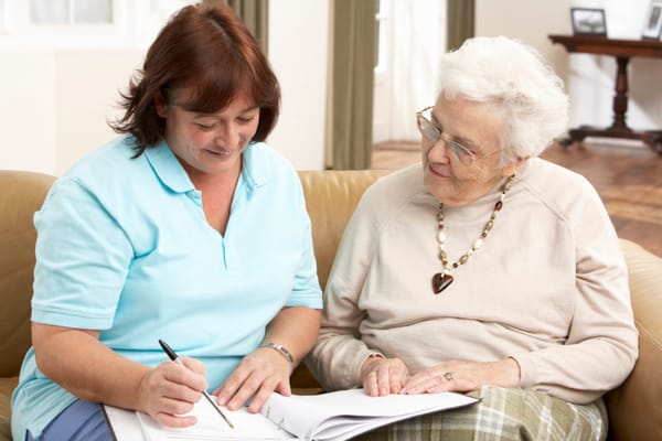 Staff member engaging with a resident in a cozy living area