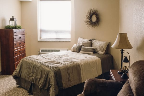 Cozy private resident room with bed and furniture