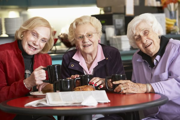 Three senior women enjoying coffee together