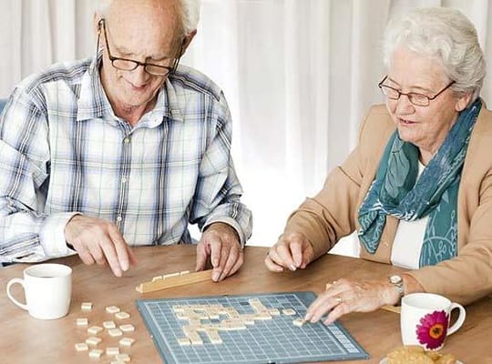Two residents playing a word game at a table