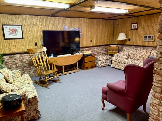 Cozy lounge area with floral furniture and a television