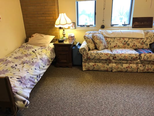 Cozy bedroom with floral decor and a sofa