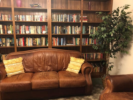 Cozy common area with a couch and bookshelves