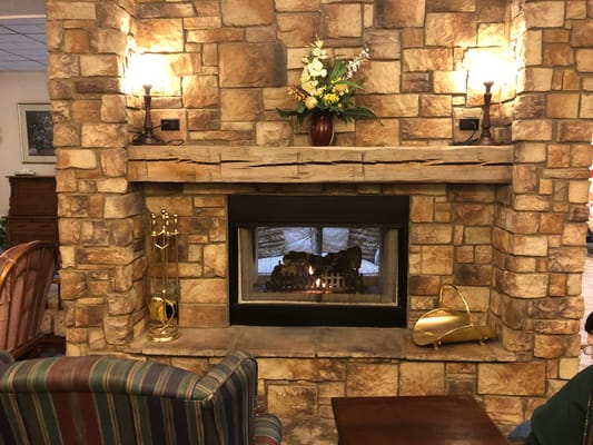 Cozy lounge area with a fireplace and seating