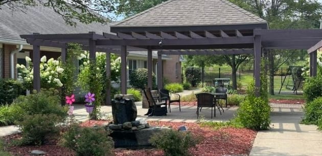 Outdoor seating area with landscaping and a water feature