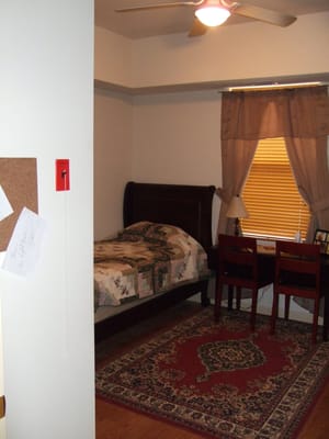 Private resident room with a bed and desk