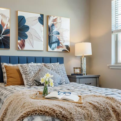 Brightly decorated bedroom with floral artwork
