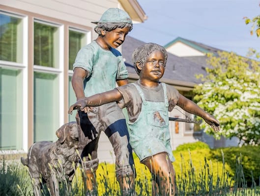 Bronze statue of children playing outside the facility