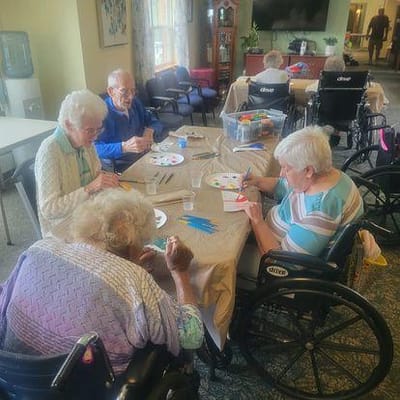 Residents engaged in a craft activity in an interior space