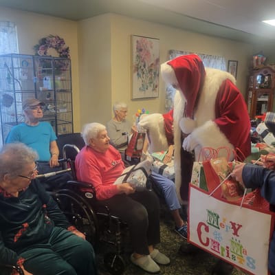 Residents participating in a Christmas celebration with Santa