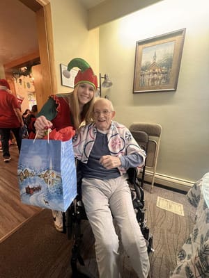Resident celebrating with staff during a festive event