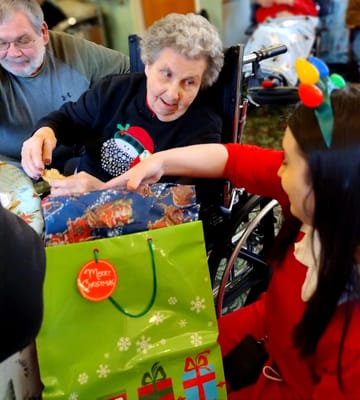 Residents enjoying a Christmas activity with gifts