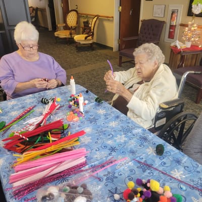 Residents engaging in a craft activity at a table