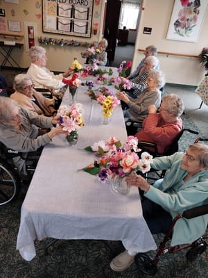 Residents arranging flowers in an activity room