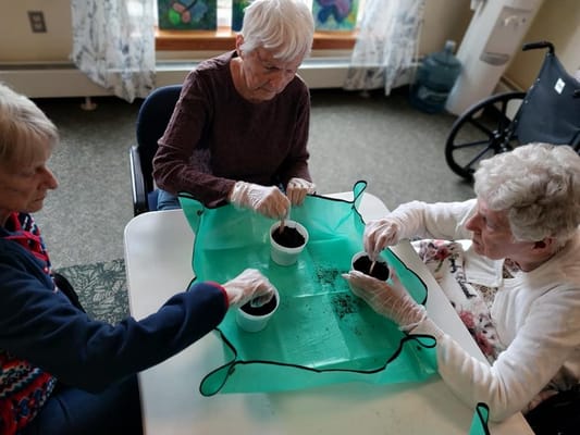 Residents participating in a planting activity indoors