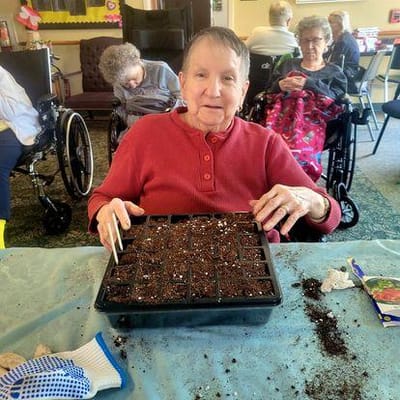 Residents engaging in gardening activities in a common area