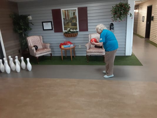 Resident participating in an indoor bowling activity
