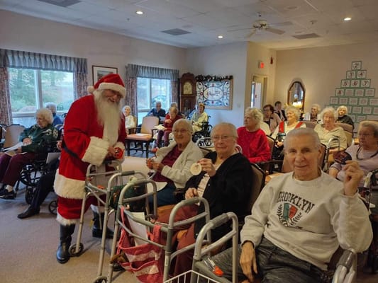 Residents celebrating with Santa Claus in a common area