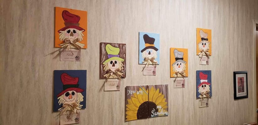 Colorful wall art featuring scarecrow decorations
