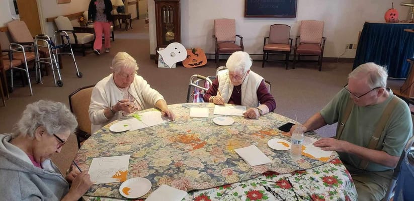 Residents engaged in a crafting activity at a table
