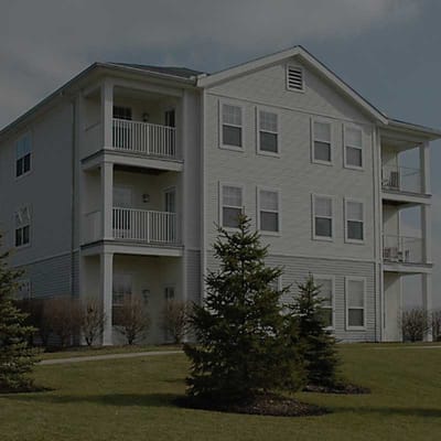 Exterior view of a senior living building with greenery