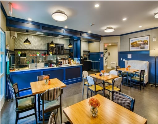 An inviting dining area with tables and a kitchen counter