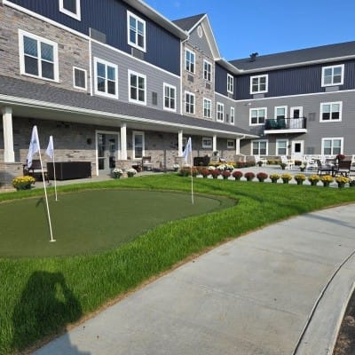 Outdoor putting green in front of a senior living facility