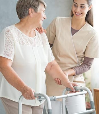 Caregiver assisting a resident with a walker