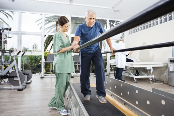 Therapist assisting a resident on a walking treadmill