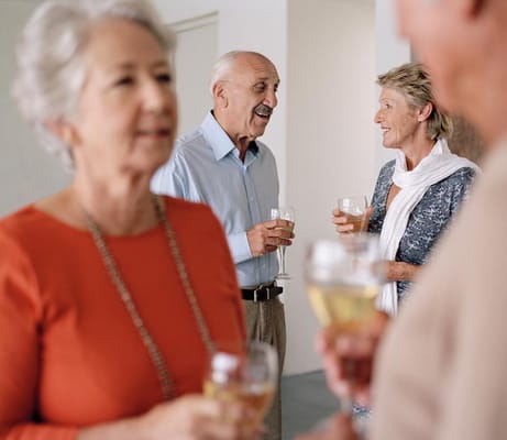 Residents enjoying drinks and conversation in a social setting