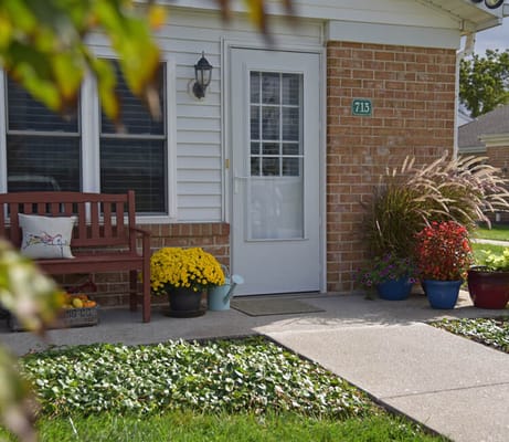 Front entrance of a residence with flower pots