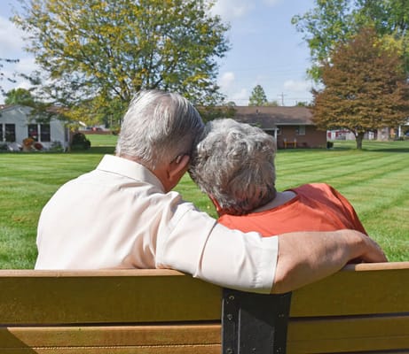 Couple sitting on a bench in a garden