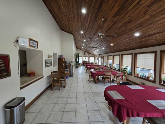 Interior view of a dining room with wooden ceiling and tables