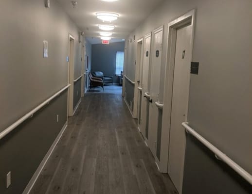 Interior hallway with resident rooms and seating