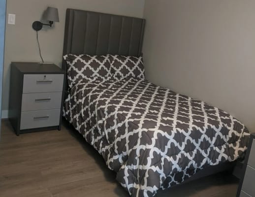 Private resident room with bed and nightstand