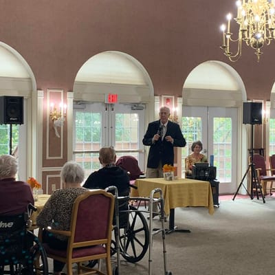 Residents enjoying a performance in the community lounge
