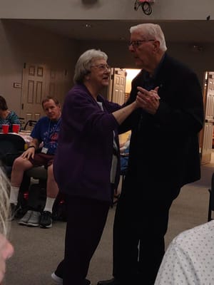 Residents dancing together at an activity event