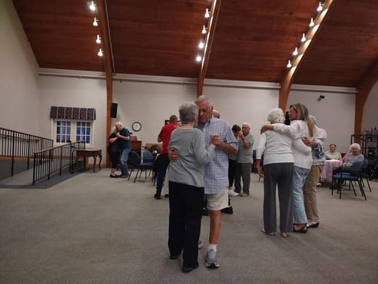 Residents dancing in a social activity room