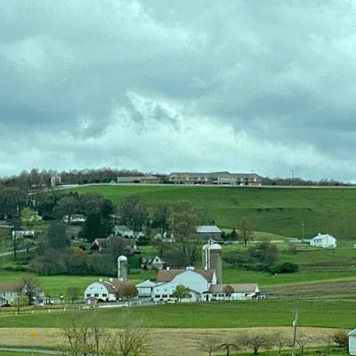 Aerial view of Sunny Crest Home and surrounding fields
